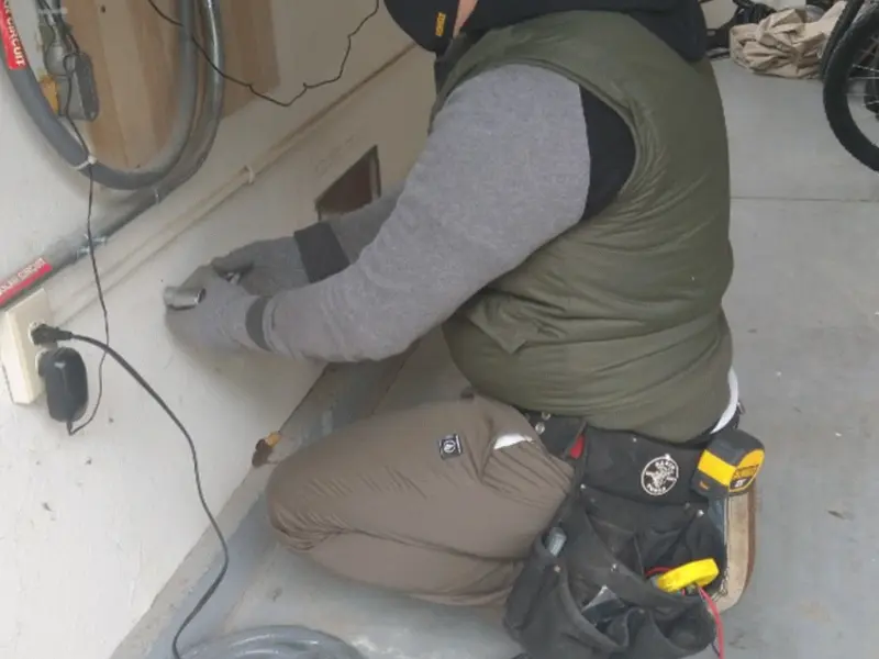 Electrician performing outlet wiring in a Winter Beach garage