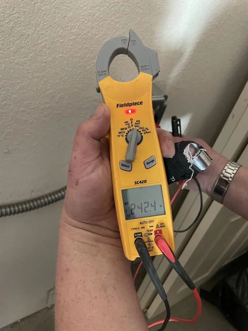 Voltage testing with clamp meter during Recessed Lighting Installation in Winter Beach
